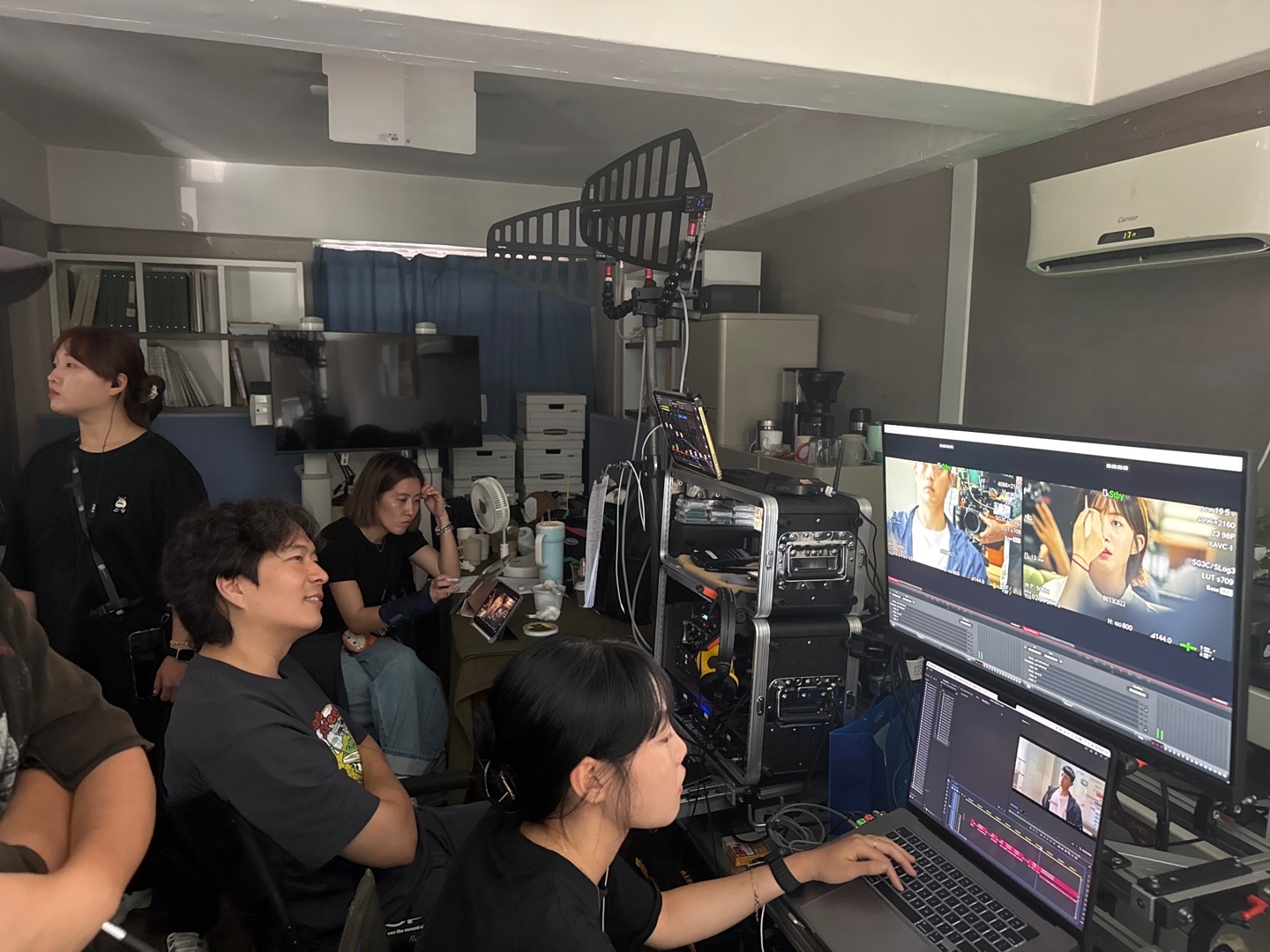 A production team reviewing camera monitors on set